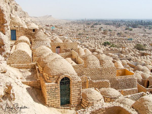 Tombs stretching on forever in Minya, Egypt Looking down at the cemetery of Zawiyyet Al Mayyiteen from its back against the hill, the mud brick domes seem to stretch on forever.
