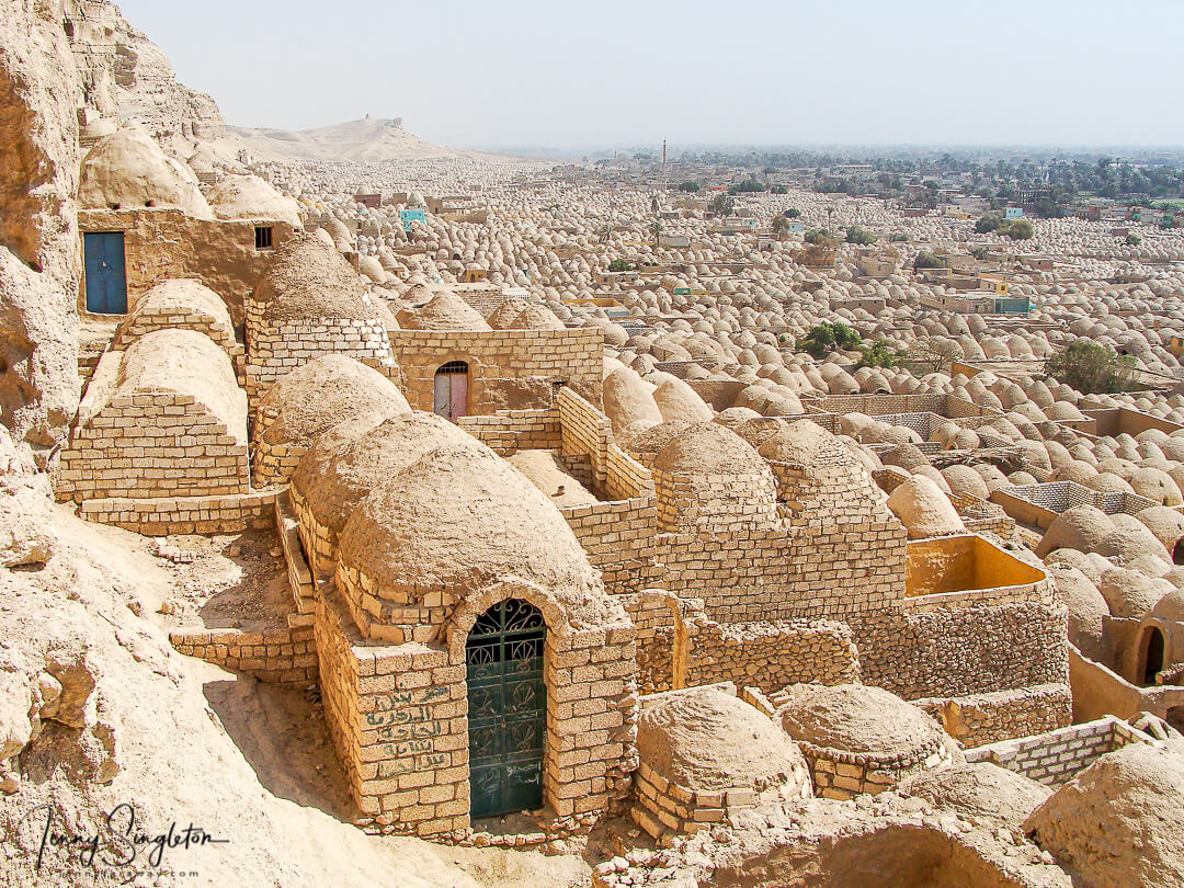 Looking down at the cemetery of Zawiyyet Al Mayyiteen from its back against the hill, the mud brick domes seem to stretch on forever.